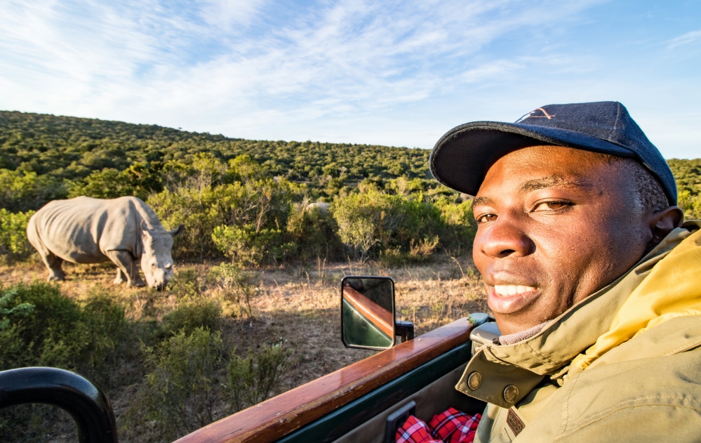 Sudan's Carer James with poaching survivor rhino Thandi at Kariega Game Reserve