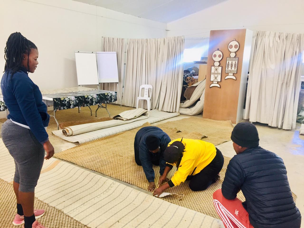 Kariega Foundation coaches cutting carpets for ECD donation