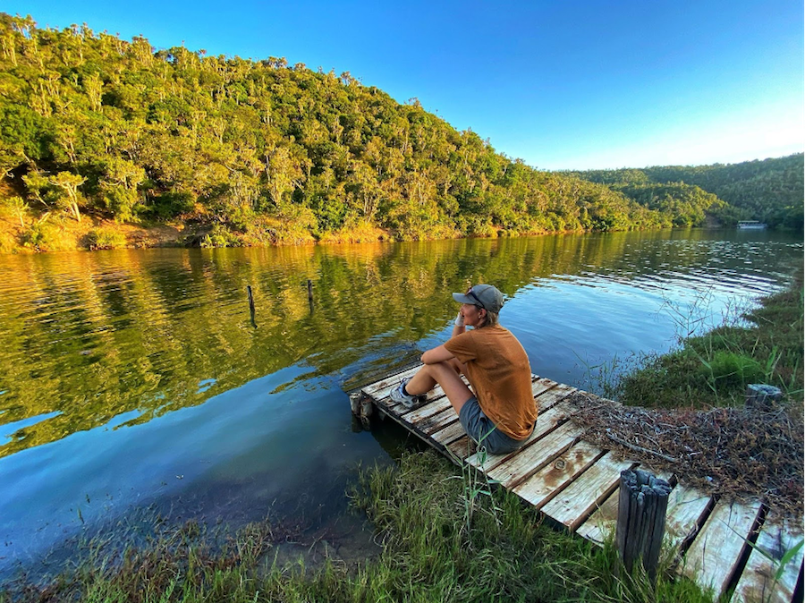 Kariega Volunteer sitting on a jetty by the river