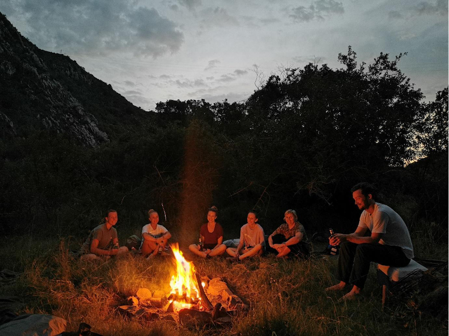 Kariega Volunteers sitting around a campfire